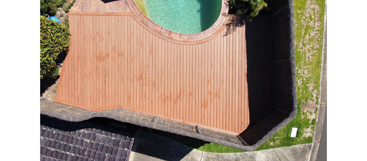 Trex tiki torch pool deck with custom curve to match pool edge and full boarder.