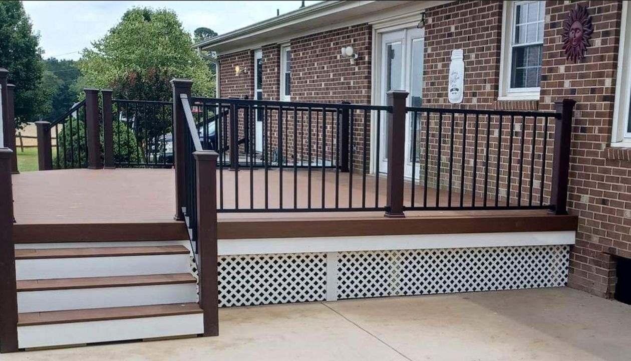 Trex Enhance Basics Saddle Deck with Signature Black Handrails works well with this brick home