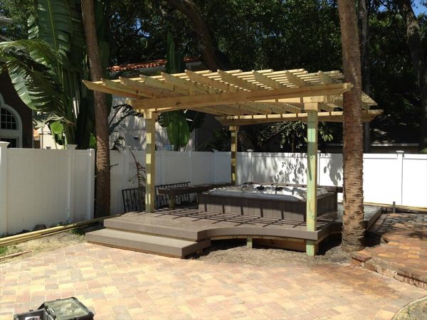 Here's an all in one package. Trex decking surrounds this custom built-in hot tub. There is seating on two sides to give the homeowner a place to relax in the shade of the pergola after a nice dip.