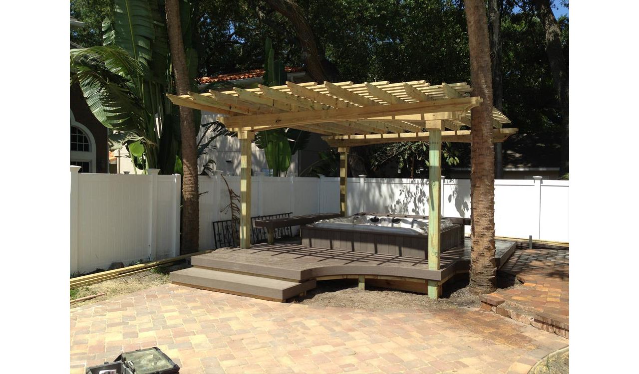 Here's an all in one package. Trex decking surrounds this custom built-in hot tub. There is seating on two sides to give the homeowner a place to relax in the shade of the pergola after a nice dip.