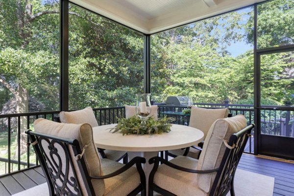 Screened in porch with decking in Trex Foggy Wharf with two Adirondack chairs looking out on the yard