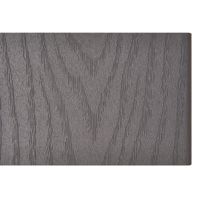 A rectangular composite decking board featuring a realistic gray wood grain texture is shown against a white background. The surface displays detailed, embossed patterns that mimic natural wood. The board is clean, with no visible text, numbers, or branding. The overall appearance is modern and neutral, suitable for outdoor or architectural use.
