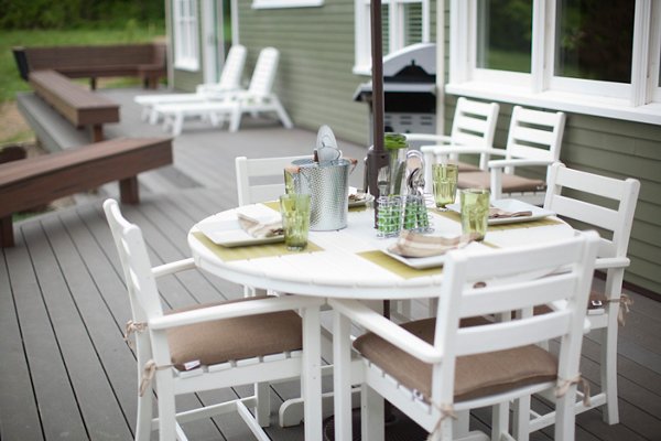 Patio under a deck with a nice family dining table and an outdoor kitchen. 