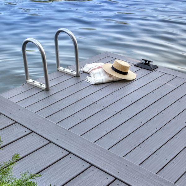 15. A sunhat and blanket laying on a dock made with Trex decking in the color Whidbey.