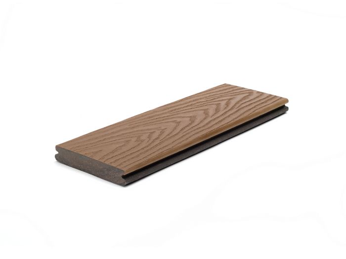 A single brown composite decking board is displayed against a white background. The board features a realistic wood grain pattern on its surface, highlighting its natural appearance. The edges show a tongue-and-groove profile, suitable for easy installation. The image focuses on the product itself, with no visible text or numbers present.