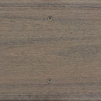 A detailed view of a wooden panel featuring a smooth, natural grain texture. Two metallic screws are clearly visible, aligned vertically near the center of the surface. The wood has a neutral brown tone, and the setting appears to be indoors with even lighting. No visible text, logos, or numbers are present in the image.