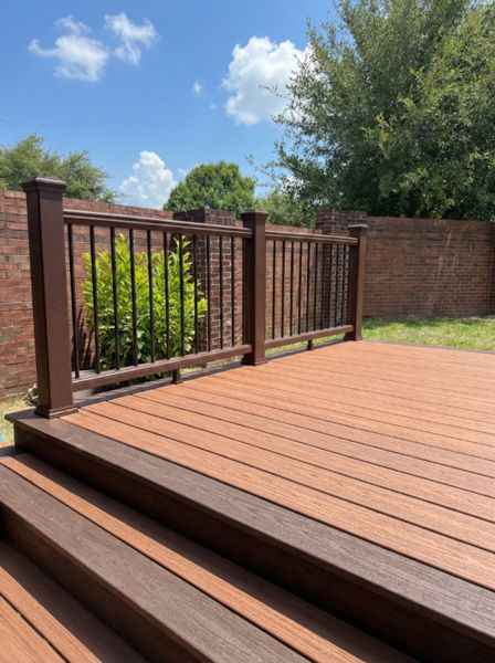 Trex composite deck with premium railing system in Houston, TX. Elevated design with wide steps for seamless indoor-outdoor transition.