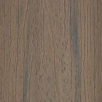 A close-up view of a brown wood grain textured surface, showcasing natural lines and grooves. The image highlights the organic pattern and tactile quality of the material. The color palette consists of earthy browns and subtle gray undertones, evoking a rustic and natural mood. No visible text, numbers, or identifiable brands are present.