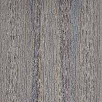 A detailed view of a gray tree bark texture, showcasing vertical grooves and natural patterns. The image highlights the organic lines and subtle variations in color, ranging from light to dark gray. No visible text, numbers, or identifiable brands are present. The overall mood is neutral and natural, suitable for backgrounds or design elements.
