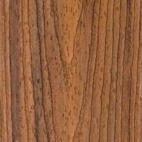 A detailed close-up of a natural wood surface, showcasing prominent brown grain patterns and subtle texture variations. The image highlights the organic lines and knots typical of wood, with warm earthy tones throughout. No visible text, numbers, or identifiable brands are present in the image.