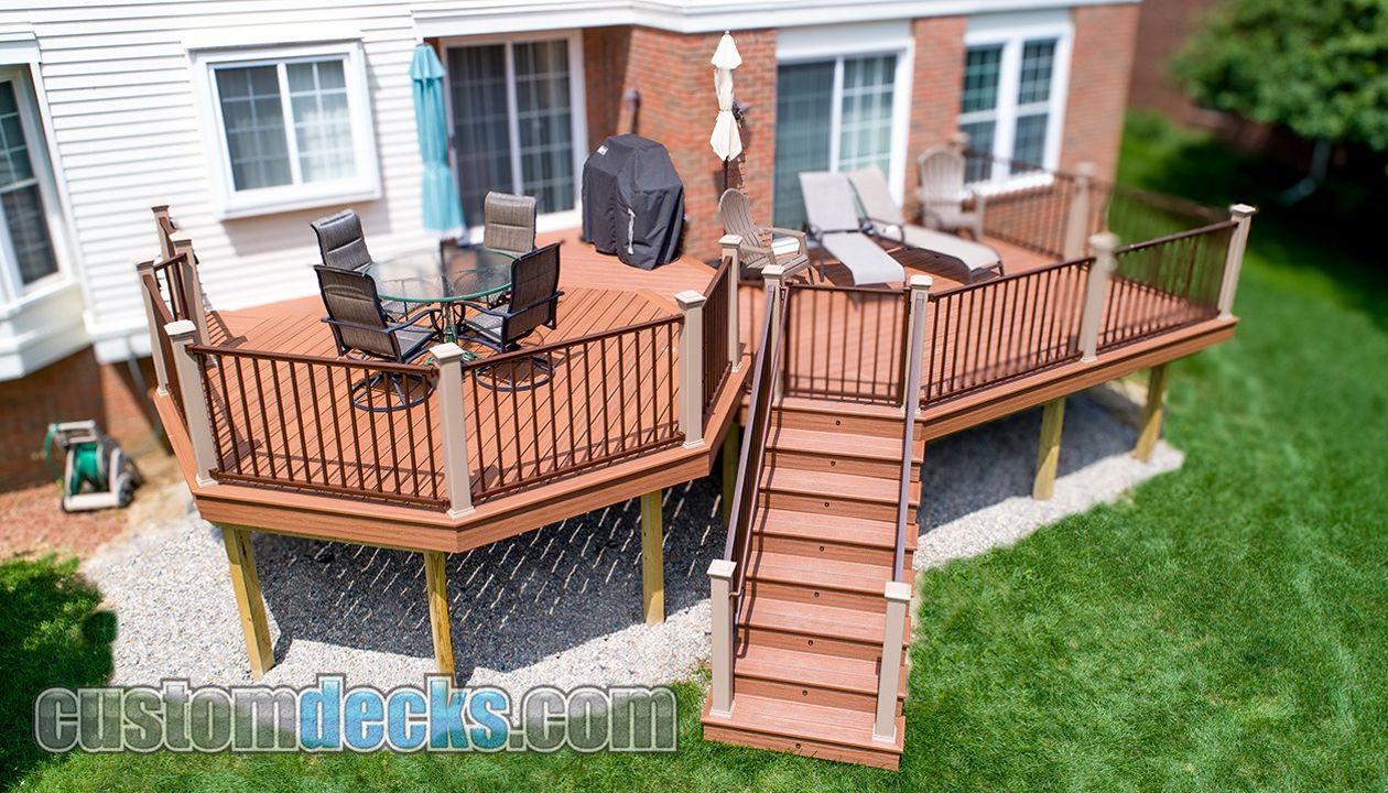 Transcends Tiki Torch decking and Bronze Signature railing with Rope Swing posts