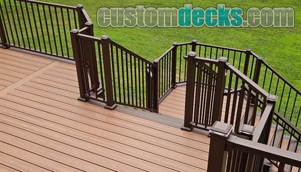 Transcends Tiki Torch decking with Spiced Rum border and Bronze Signature railing with matching post cap lighting