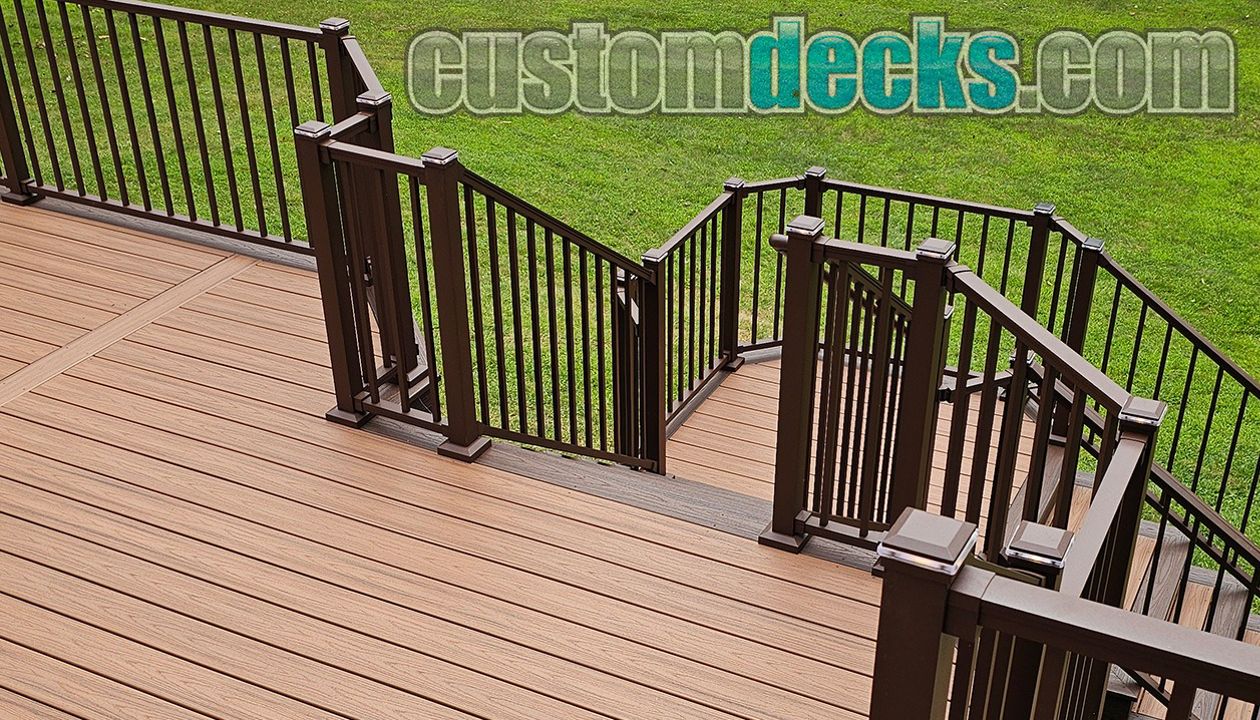 Transcends Tiki Torch decking with Spiced Rum border and Bronze Signature railing with matching post cap lighting