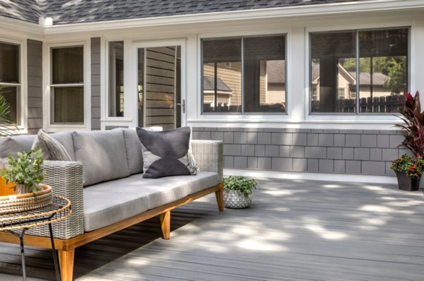 Patio under a deck with a nice family dining table and an outdoor kitchen. 