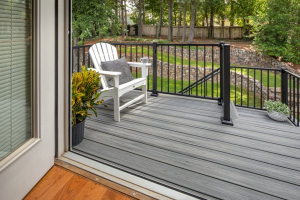 Adirondack chair on small deck overlooking backyard