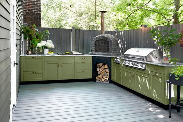  Outdoor L-shaped green kitchen with brick oven on fenced-in deck