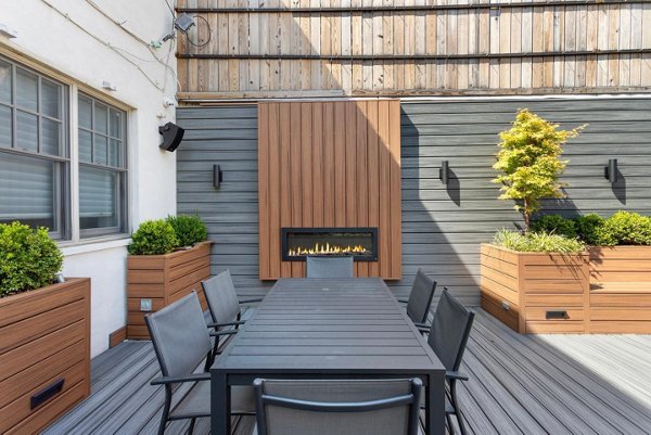 Beautiful brown Trex fence with a lawn and garden. 