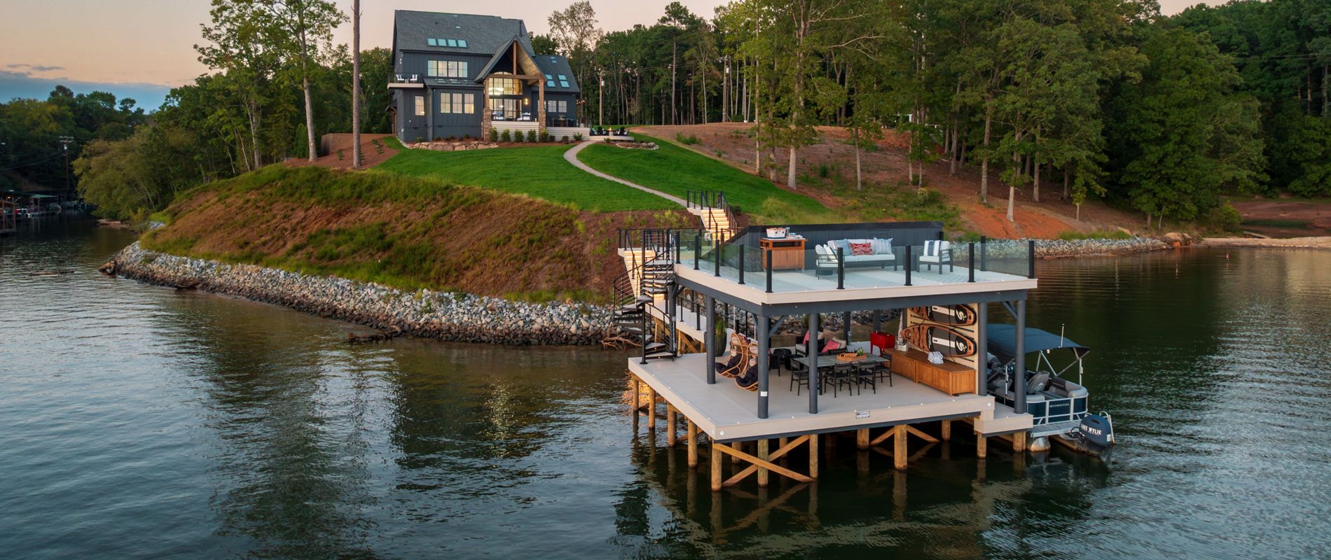 A view of the new HGTV 2026 Dream Home where you can see Trex decking and outdoor products accenting the home beautifully as well as the path to the Trex dock on the lake.