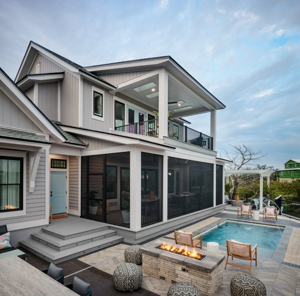 Screened in porch with decking in Trex Foggy Wharf with two Adirondack chairs looking out on the yard