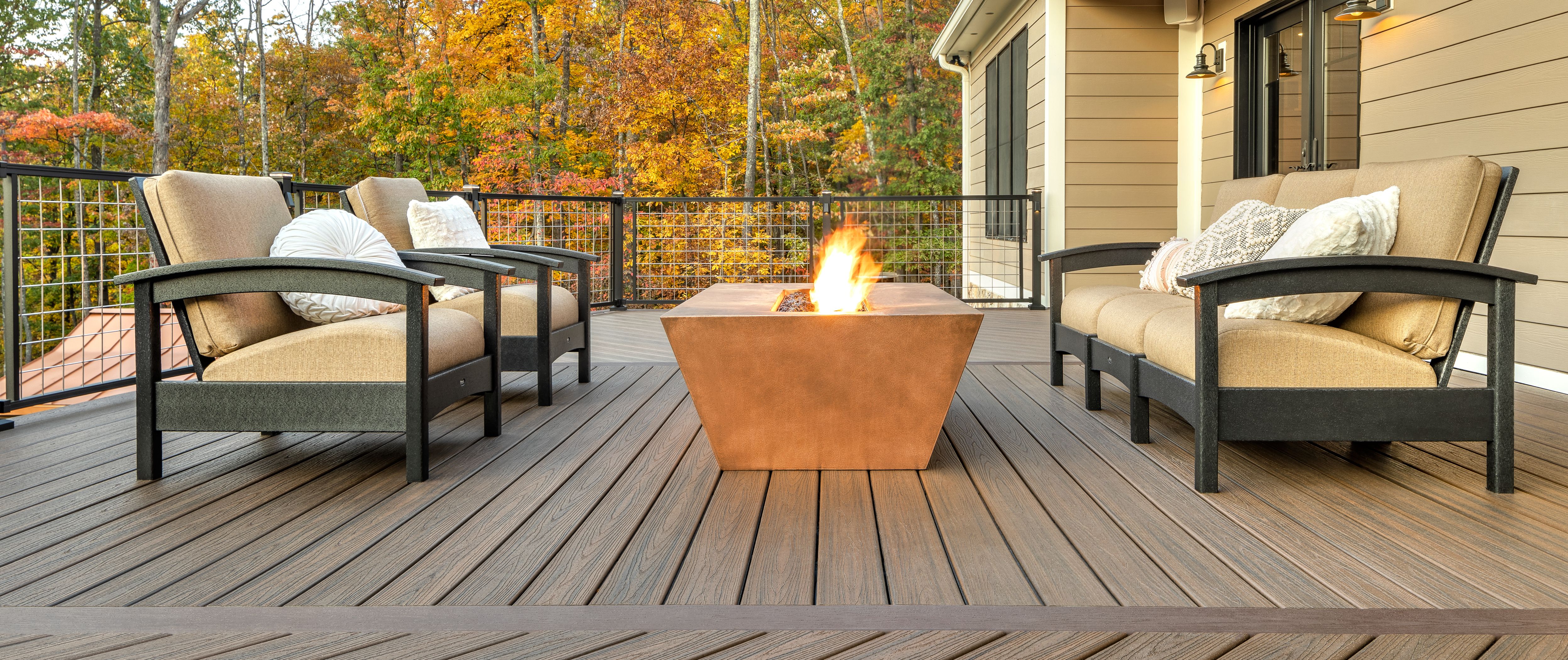 https://images.trex.com/is/image/trexcompany/trn-taylor-003-sr-sig-mesh-railing-bk-furniture-around-firepit%3APrimary%20Hero?dpr=on%2C2.625&ts=1765990714883