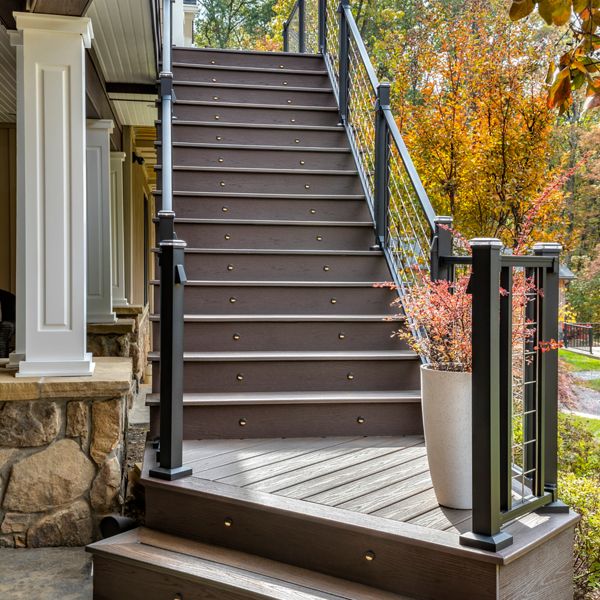 Trex stair lights in the brown fascia of brown Trex deck stairs.