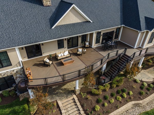   Curved composite deck and metal railings in the backyard