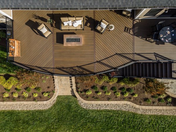 A deck view from above in the Trex Transcend color Spiced Rum lined with a Trex Signature Mesh black railing.