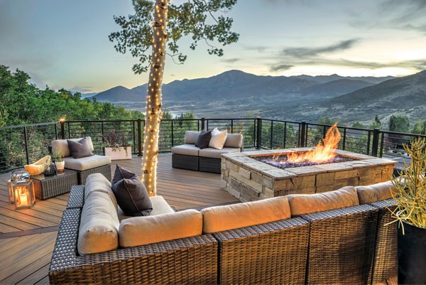 Patio under a deck with a nice family dining table and an outdoor kitchen. 