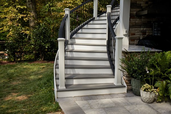 Stairs curving toward a garden patio